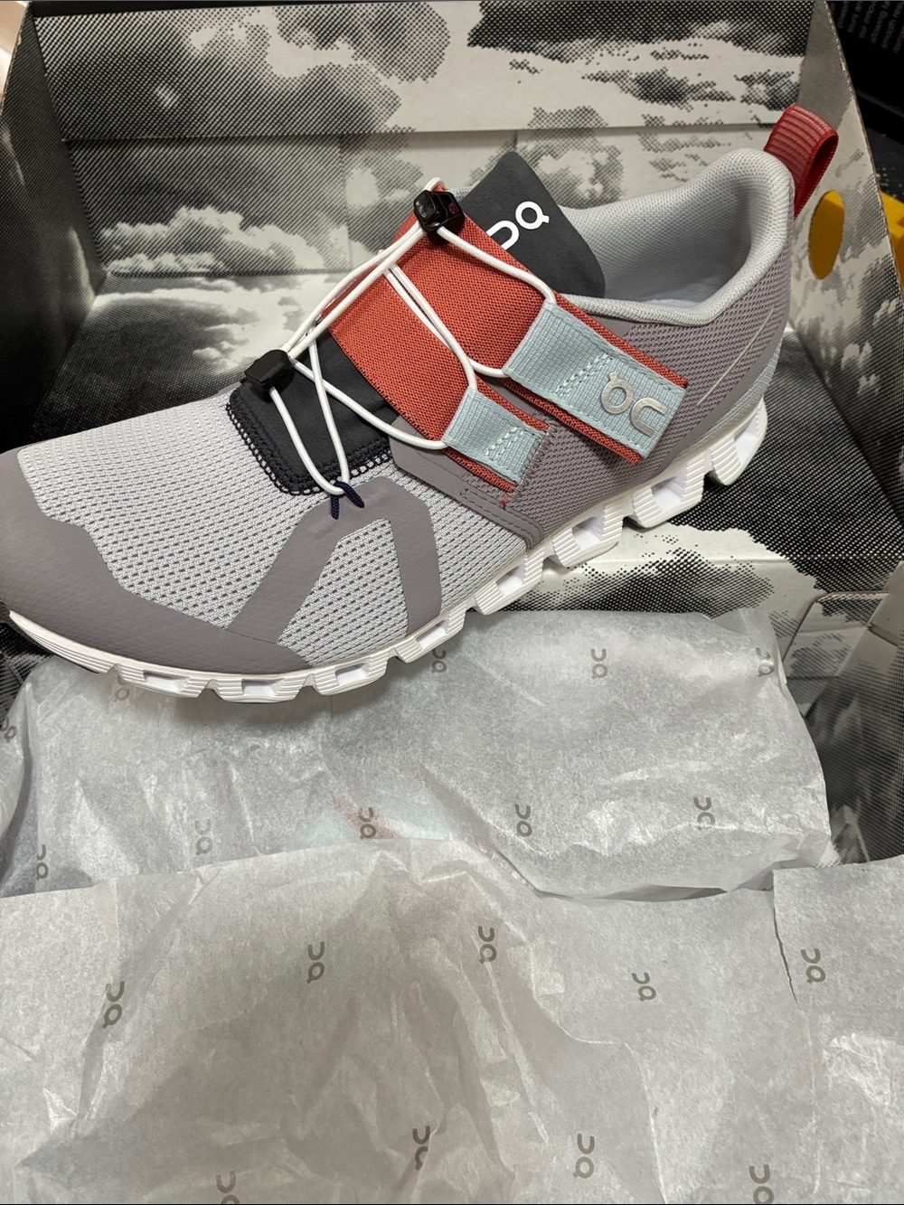 On Cloud Running women’s Athletic Shoe in Gray with Rust and Pale Blue Accents